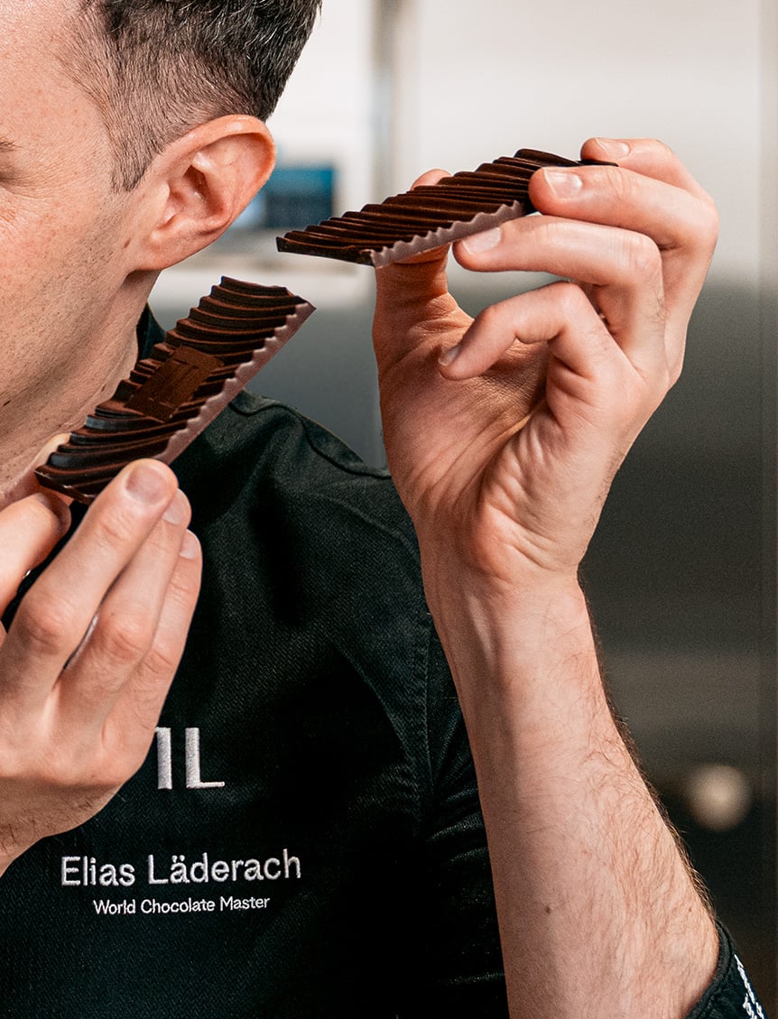 Chocolatier listening to the snap of the chocolate