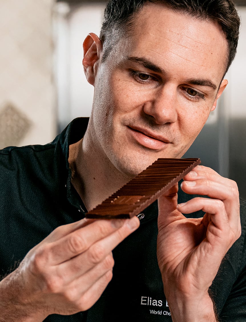 Chocolatier examining the satin shine of the chocolate