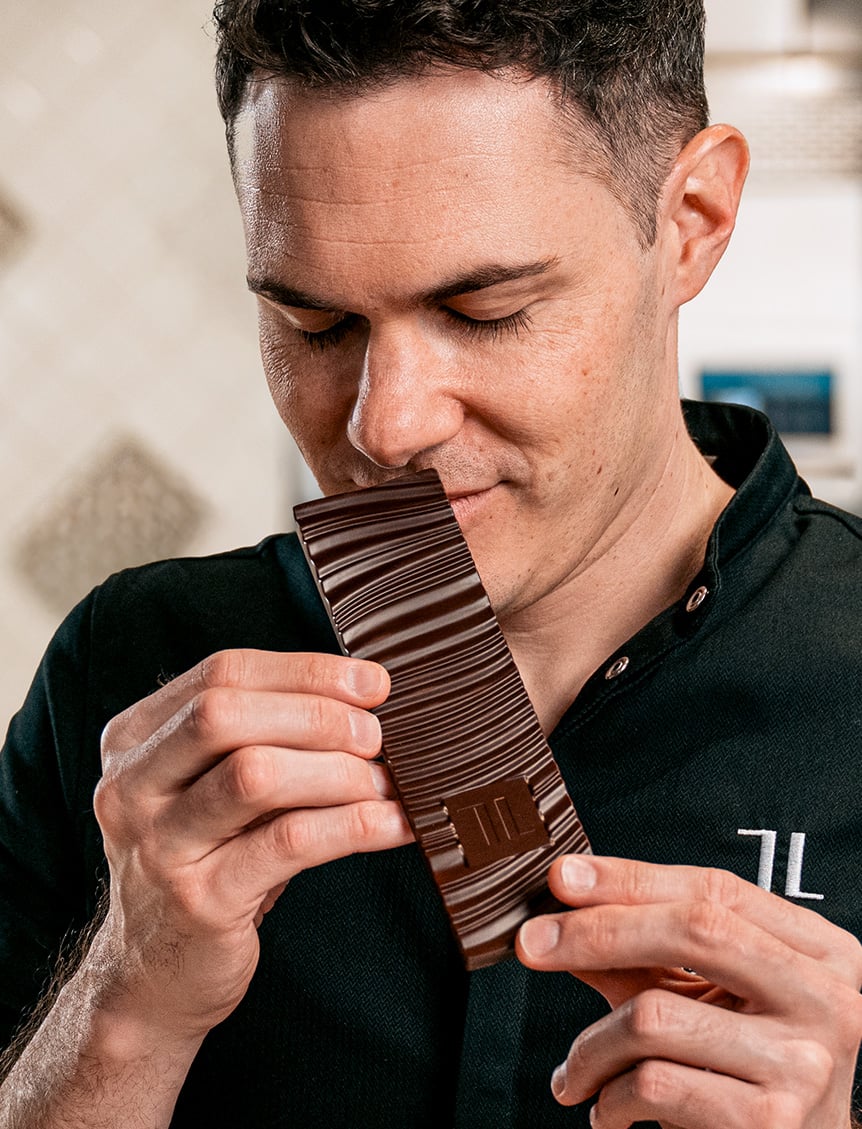Chocolatier smelling a chocolate
